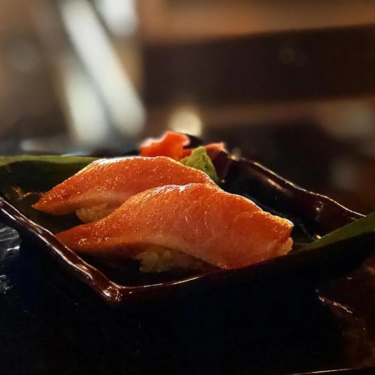 a small food tray with two pieces of sushi